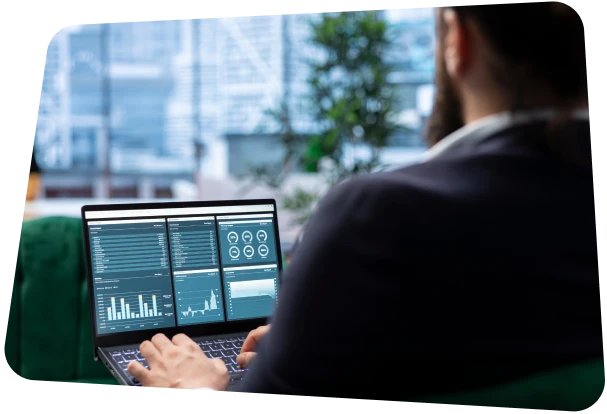 Operator monitoring energy dashboards from a control desk